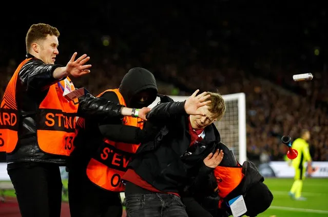 A pitch invader is detained by stewards during Europa League quarter final match between West Ham United and Olympique Lyonnais at London Stadium, London, Britain on April 7, 2022. (Photo by Andrew Boyers/Action Images via Reuters)