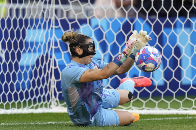 Spain's goalkeeper Cata Coll stops a penalty by Colombia's Catalina Usma in a penalty shootout during the women's quarter-final soccer match between Spain and Colombia, at Lyon Stadium, during the 2024 Summer Olympics, Saturday, August 3, 2024, in Decines, France. (Photo by Silvia Izquierdo/AP Photo)