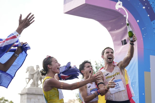 Australia's Rhydian Cowley, left, Australia's Jemima Montag Spain's Maria Perez and Spain's Alvaro Martin celebrate after crossing the finish line at the end of the marathon race walk relay mixed at the 2024 Summer Olympics, Wednesday, August 7, 2024, in Paris, France. (Photo by Vadim Ghirda/AP Photo)