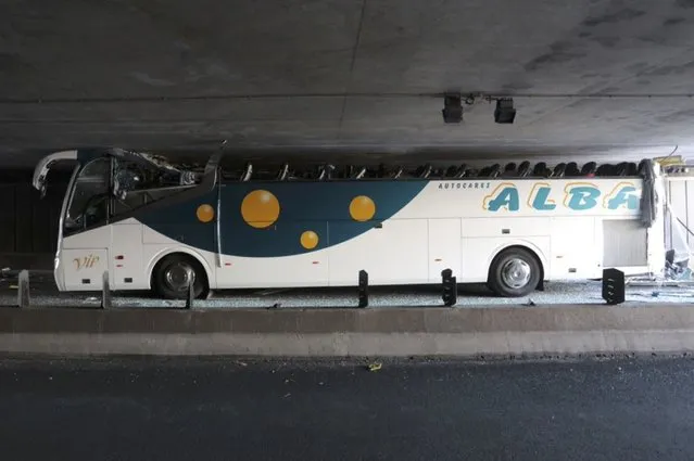 A Spanish tour bus is seen inside a mini-tunnel with its roof sheared off at the scene of the accident in La Madeleine, France, near Lille, July 26, 2015. Twenty-eight passengers were injured in the accident, four seriously, according to French media reports. (Photo by Reuters/Stringer)