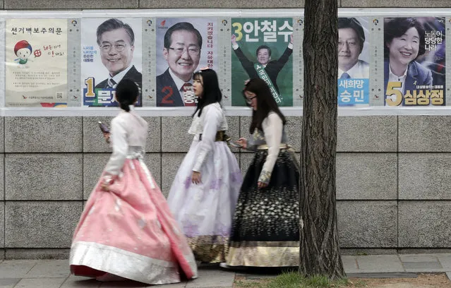 Women walk by posters showing candidates for the presidential election in Seoul, South Korea, Tuesday, May 9, 2017. South Koreans voted Tuesday for a new president, with victory widely predicted for a liberal candidate who has pledged to improve ties with North Korea, re-examine a contentious U.S. missile defense shield and push sweeping economic changes. (Photo by Lee Jin-man/AP Photo)