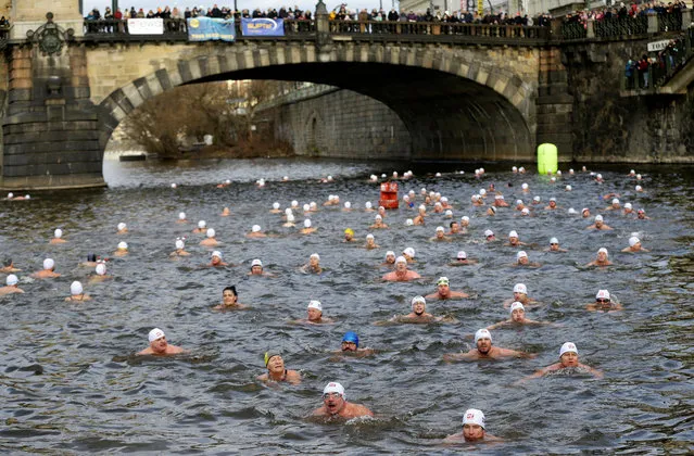 Swimmers participate in the annual Christmas winter swimming competition in the Vltava river in Prague, Czech Republic, December 26, 2019. (Photo by David W. Cerny/Reuters)