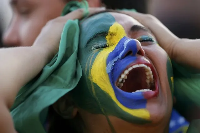 Fans of Brazil react while watching a broadcast of the 2014 World Cup semi-final against Germany at the Fan Fest in Brasilia, July 8, 2014. (Photo by Ueslei Marcelino/Reuters)