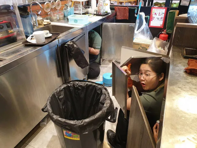 Coffee shop staff hide as a gunman goes on a shooting spree in Nakhon Ratchasima, Thailand on Sunday, February 9, 2020. (Photo by Viral Press/The Sun)