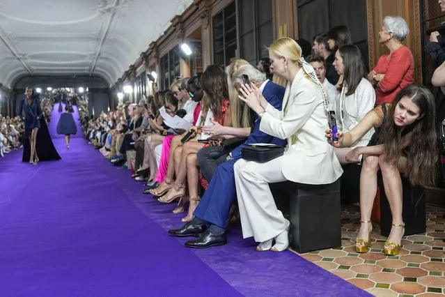 A spectator, right, uses a cell phone to record the Mabille Haute Couture Fall/Winter 2022-2023 fashion collection presented Tuesday, July 5, 2022 in Paris. (Photo by Michel Euler/AP Photo)