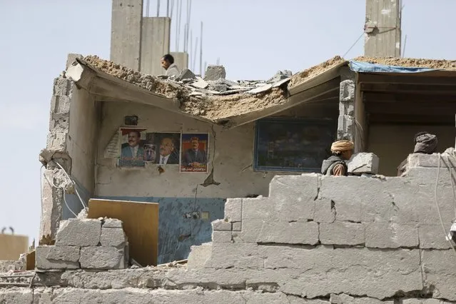 Posters of Yemen's former president Ali Abdullah Saleh are seen on the wall of a room in a house destroyed by Saudi-led air strikes on the nearby offices of the education ministry's workers union in Yemen's northwestern city of Amran August 19, 2015. (Photo by Khaled Abdullah/Reuters)