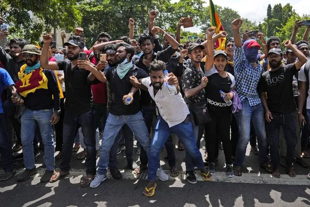 Protesters shout slogans before storming the Sri Lankan Prime Minister Ranil Wickremesinghe's office, demanding he resign after president Gotabaya Rajapaksa fled the country amid economic crisis in Colombo, Sri Lanka, Wednesday, July 13, 2022. Sri Lanka’s president fled the country without stepping down Wednesday, plunging a country already reeling from economic chaos into more political turmoil. Protesters demanding a change in leadership then trained their ire on the prime minister and stormed his office. (Photo by Rafiq Maqbool/AP Photo)