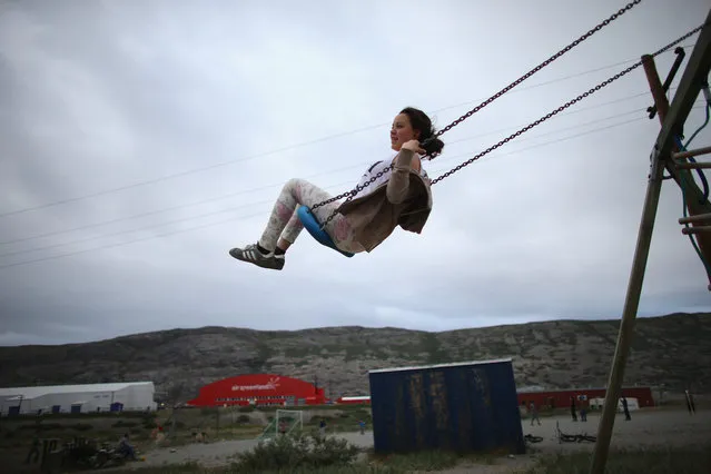 Francica Olsem plays on a swing on July 09, 2013 in Kangerlussuaq, Greenland. (Photo by Joe Raedle/Getty Images)