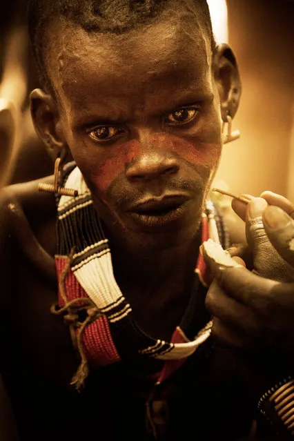 Using only the clay, they can make face paint that is ocher, red, yellow, white, and grey. They usually apply the paint with fingers, but occasionally use reeds as paintbrushes. (Photo by Diego Arroyo)