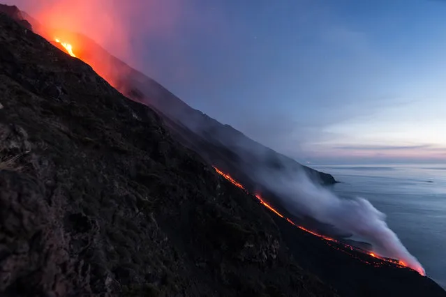 Hot lava trickles down from the Stromboli volcano on August 9, 2014 in Aeolian Islands, Italy. Lava flows down the Mount Stromboli off the Sicilian coast in southern Italy. The volcano – at 3,034ft – is one of the most active in Europe and has been erupting continuously since 1932. (Photo by Tom Pfeiffer/Barcroft Media)