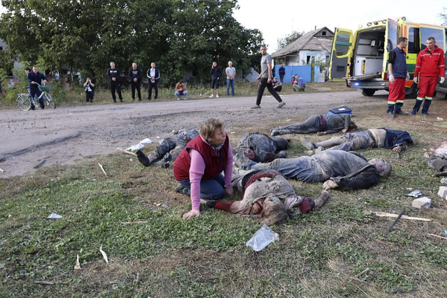 In this photo provided by the Ukrainian Presidential Press Office, a woman reacts near the bodies of victims of the deadly Russian rocket attack that killed at more than 40 people in the village of Hroza near Kharkiv, Ukraine, Thursday, October 5, 2023. (Photo by Ukrainian Presidential Press Office via AP Photo)