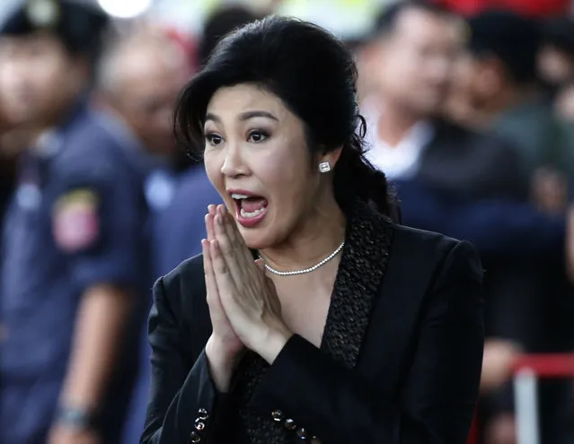 In this August 1, 2017, file photo, Thailand's former Prime Minister Yingluck Shinawatra greets supporters as she arrives at the Supreme Court to make her final statements in a trial on a charge of criminal negligence in Bangkok, Thailand.  A Thai court on Wednesday, September 27, 2017, has sentenced former Prime Minister Yingluck Shinawatra in absentia to five years in prison for alleged negligence in a money-losing rice subsidy program. (Photo by Sakchai Lalit/AP Photo)