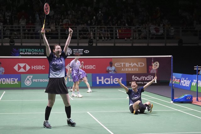 Japan's Yuki Fukushima, right and Mayu Matsumoto celebrate after defeating China's Jia Yi Fan and Zhang Shun Xian in their women's doubles badminton finals match at the Malaysia Open tournament at Bukit Jalil Axiata Arena in Kuala Lumpur, Malaysia, Sunday, January 12, 2025. (Photo by Kien Huo/AP Photo)