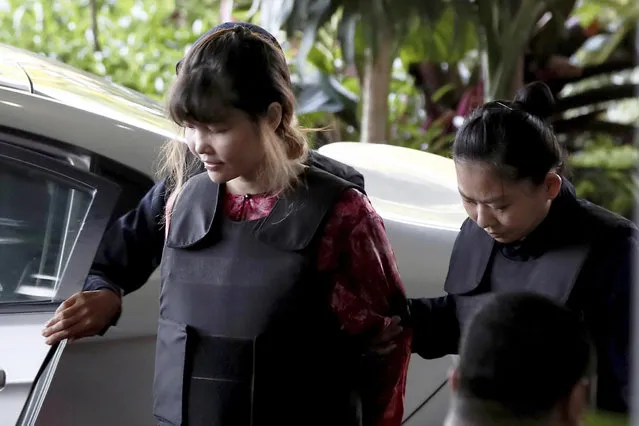 Vietnamese Doan Thi Huong, left, is escorted by police as she arrives for court hearing at Shah Alam court house in Shah Alam, outside Kuala Lumpur, Malaysia Thursday, October 5, 2017. Doan and Siti Aisyah of Indonesia have pleaded not guilty to killing Kim Jong Nam on Feb. 13 at a crowded Kuala Lumpur airport terminal. They are accused of wiping VX on Kim's face in an assassination widely thought to have been orchestrated by North Korean leader Kim Jong Un. (Photo by Sadiq Asyraf/AP Photo)