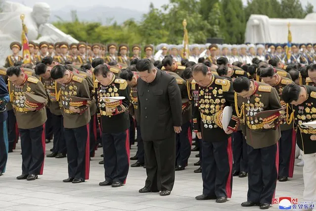 In this photo provided by the North Korean government, North Korean leader Kim Jong Un, center front,  visits a liberation war martyrs cemetery in Pyongyang, North Korea on the 69th anniversary of the signing of the ceasefire armistice that ends the fighting in the Korean War, Wednesday, July 27, 2022. (Photo by Korean Central News Agency/Korea News Service via AP Photo)