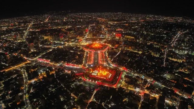 An aerial view shows Iraq's holy city of Karbala as Shiite Muslim pilgrims gather to mark the Arbaeen religious commemoration, late on September 15, 2022. Every year, Shiite pilgrims converge in large numbers to the holy Iraqi cities of Najaf and Karbala ahead of Arbaeen, which marks the 40th day after Ashura, commemorating the seventh century killing of Prophet Mohammed's grandson Imam Hussein. (Photo by Mohammed Sawaf/AFP Photo)