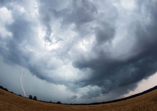 Dark storm clouds and lightning near Steinhoefel, Germany, 16 August 2015. (Photo by Patrick Pleul/EPA)