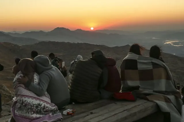 Stargazers gather to watch the Perseid meteor shower among ancient statues atop Mount Nemrut in southeastern Turkey, Saturday, August 13, 2022. Hundreds spent the night at the UNESCO World Heritage Site for the annual meteor show that stretches along the orbit of the comet Swift–Tuttle. Perched at an altitude of 2,150 meters (over 7,000 feet), the statues are part of a temple and tomb complex that King Antiochus I, of the ancient Commagene kingdom, built as a monument to himself. (Photo by Emrah Gurel/AP Photo)