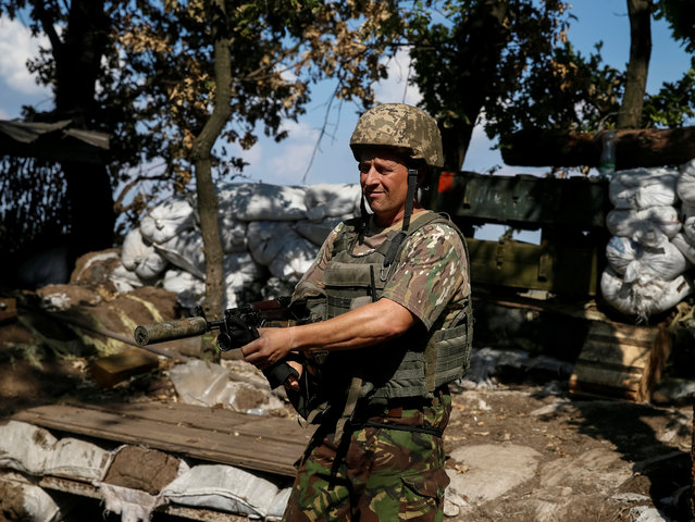 Ukrainian serviceman is seen at his position on the front line in Krasnogorivka near Donetsk, Ukraine, August 12, 2016. (Photo by Gleb Garanich/Reuters)