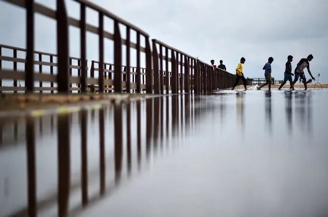 Boys wade through the flooded Marina beach following heavy rainfall, in Chennai, India, 02 November 2022. The Indian Meteorological Department (IMD) predicts heavy rains and thunderstorms to continue in the state of Tamil Nadu for the next few days as Chennai and its adjoining districts witnessed heavy rainfall for the past two days. Houses in low-lying areas get flooded with rainwater in some parts of Chennai. Schools and colleges remained closed in the 9 districts in the state of Tamil Nadu due to heavy downpours. (Photo by Idrees Mohammed/EPA/EFE/Rex Features/Shutterstock)