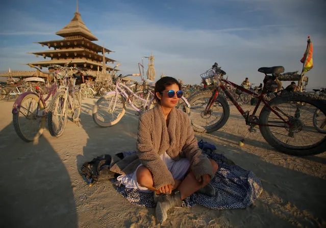 Marianna Phillips sits near the Temple Project as approximately 70,000 people from all over the world gather for the 30th annual Burning Man arts and music festival in the Black Rock Desert of Nevada, U.S. September 2, 2016. (Photo by Jim Urquhart/Reuters)