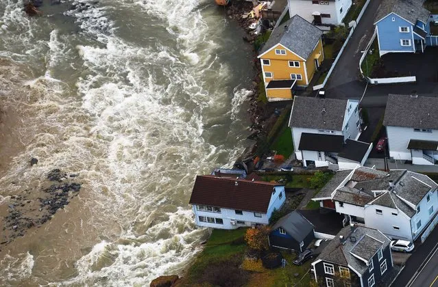 Houses, bridges and roads are damaged by flooding after heavy rain fell in Voss, western Norway on October 29, 2014. Houses have practically been flushed out into the roaring rivers. The cultural center of the community is situated on the banks of the river Opo in Voss. (Photo by Marit Hommedal/AFP Photo)