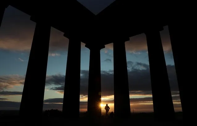 People watch the sunrise from Penshaw Monument, County Durham, Britain on July 29, 2020. (Photo by Lee Smith/Reuters)