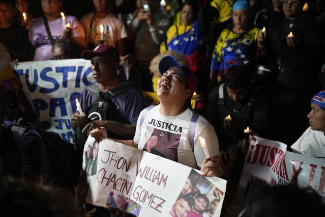 People holding photos of their relatives, who were deported from the U.S. and transferred to a prison in El Salvador after the U.S. alleged they were members of the Tren de Aragua gang, cry and pray outside of the Salvadoran embassy in Caracas, Venezuela, Wednesday, April 2, 2025. (Photo by Ariana Cubillos/AP Photo)