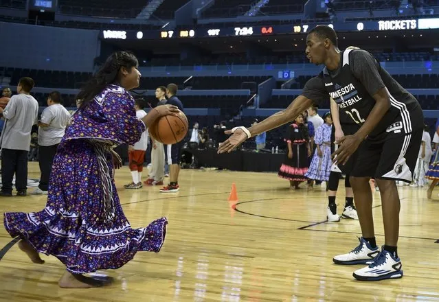Female members of the Taraumara natives basketball team take part in a clinic with NBA players of Houston Rockets and Minnesota Timberwolves at the Arena Mexico on November 11, 2014. NBA teams Minnesota Timberwolves and Houston Rockets are in Mexico to dispute a game next November 12. (Photo by Yuri Cortez/AFP Photo)