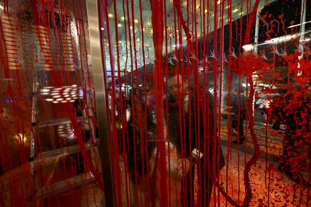Sana Hotel employees clean up the main entrance after Climaximo members splashed it with red paint protesting against climate changebefore the President of PSD and leader of Democratic Alliance (AD) Luis Montenegro dwould deliver the victory speech at elections night HQ at Sana Hotel after AD proclaimed victory on March 10, 2024, in Lisbon, Portugal. Montenegro said speaking to supporters that “to win is to have one more vote”, and called for dialog among Portuguese political parties. He insisted that there will be no political alliance with far-right Chega, that came in in a strong 3rd place with up to 44 MPs in the new Portuguese Parliament. In a speech conceding defeat Socialist leader Pedro Nuno excluded left-wing majority from governance. Portuguese early legislative elections were hold on March 10, 2024 with all the Parliament's 230 seats being at stake. Portuguese crisis began on November 7, 2023, when the Public Prosecutor's Office ordered a search that included the Prime Minister's office, the Ministry of the Environment and Climate Action and the Ministry of Infrastructure, while investigating active and passive corruption and prevarication in relation to concessions for lithium mining in northern Portugal, a project for a green hydrogen production plant and a project for a data center. This led to the resignation of Antonio Costa and the fall of Portugal's XXIII Constitutional Government. President Marcelo Rebelo de Sousa decreed the dissolution of parliament on January 15, previously announced on November 09, 2023, and the calling of early legislative elections. (Photo by Horacio Villalobos#Corbis/Corbis via Getty Images)