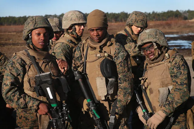 Male and female Marines wait their turn on the range during a combat marksmanship course at Marine Combat Training (MCT) on February 20, 2013 at Camp Lejeune, North Carolina. Since 1988 all non-infantry enlisted male Marines have been required to complete 29 days of basic combat skills training at MCT after graduating boot camp. It has been required for enlisted female Marines since 1997. About six percent of enlisted Marines are female.  (Photo by Scott Olson)