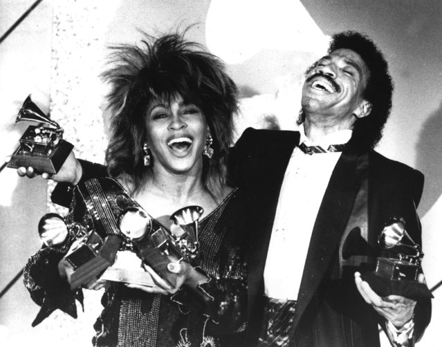 American-born and naturalized Swiss singer Tina Turner, left, and American singer-songwriter Lionel Richie pose with a total of five awards between them, at the Grammy Awards show in Los Angeles on February 27, 1985. Turner, the unstoppable singer and stage performer, died Tuesday, after a long illness at her home in Küsnacht near Zurich, Switzerland, according to her manager. She was 83. (Photo by Lennox McLendon/AP Photo)