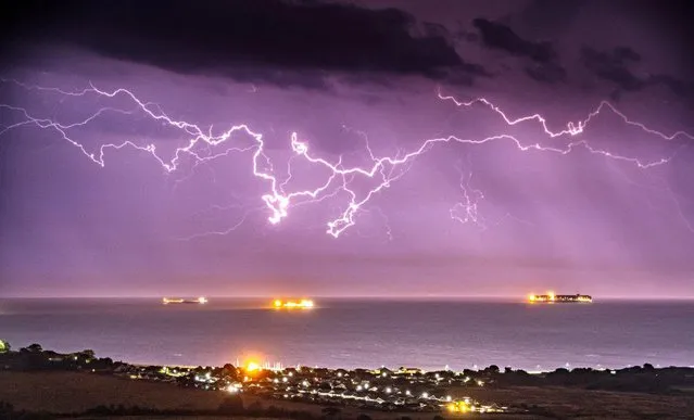 Lightning strikes over the English Channel, captured from Brading Down on the Isle of Wight on August 26, 2022. (Photo by Jamie Russell/Bournemouth News)