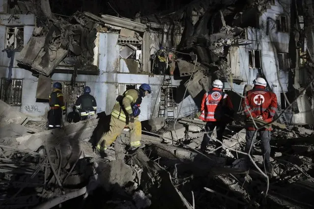 Ukrainian State Emergency Service firefighters inspect a damaged house after Russian shelling hit in Zaporizhzhia, Ukraine, Thursday, March 2, 2023. (Photo by Kateryna Klochko/AP Photo)