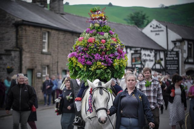 Garland Day Celebration In Castleton, Derbyshire on May 29, 2024 sees a framework of cut flowers prepared by local villagers placed on the head of the King (John Turner) then paraded around the town on horseback dressed in Stuart costume. Garland day dates back to the 1700Os and though its true origins are not fully understood it is believed to be an ancient fertility rite with Celtic connections. (Photo by Guy Corbishley/Alamy Live News)