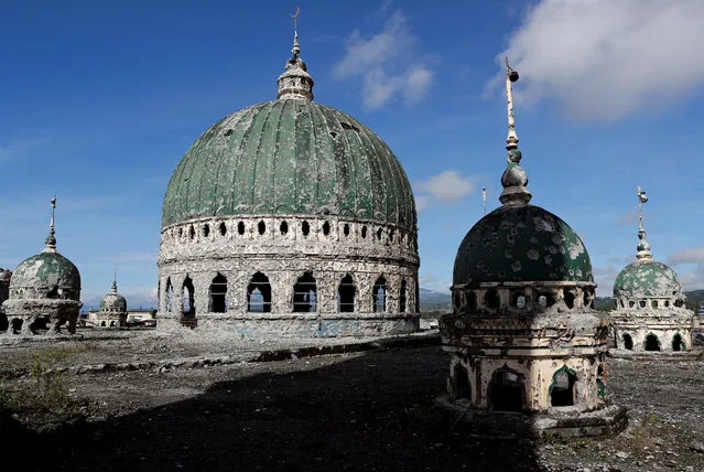 The bullet-riddled domes of Grand Mosque are seen, after residents were allowed to return to their homes for the first time since the battle between government troops and Islamic State militants began on May 2017, at the Islamic city of Marawi, Philippine on April 19, 2018. (Photo by Erik De Castro/Reuters)