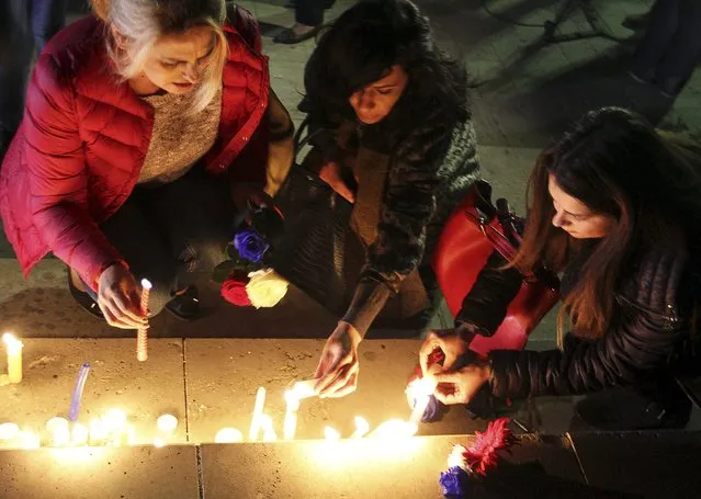People light candles for the victims of the Paris attacks, in central Tirana, Albania, November 14, 2015. (Photo by Arben Celi/Reuters)