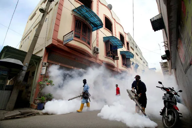 City officers conduct mosquito fogging to combat dengue at a residential complex in Lhokseumawe, Indonesia Aceh province, October 26, 2016 in this picture taken by Antara Foto. (Photo by Rahmad/Reuters/Antara Foto)