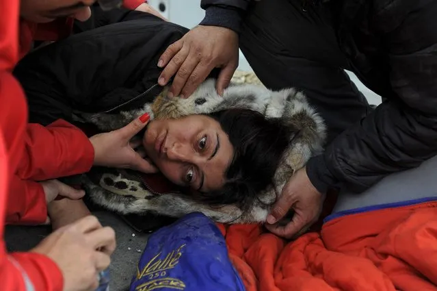 A woman collapses during a demonstration as migrants wait to cross the Greek-Macedonian borders near the village of Idomeni, Greece November 22, 2015. (Photo by Alexandros Avramidis/Reuters)