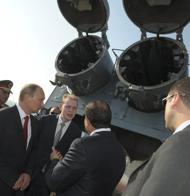 Vladimir Putin and his Egyptian counterpart Abdel Fattah al-Sisi (2nd R) talk on the deck of guided missile cruiser Moskva at the Black Sea port of Sochi, August 12, 2014. (Photo by Alexei Druzhinin/Reuters/RIA Novosti/Kremlin)