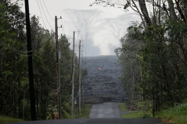 The Kilauea lava flow cuts off Kahukai Street, in the Leilani Estates near Pahoa, Hawaii, U.S., May 29, 2018. (Photo by Marco Garcia/Reuters)