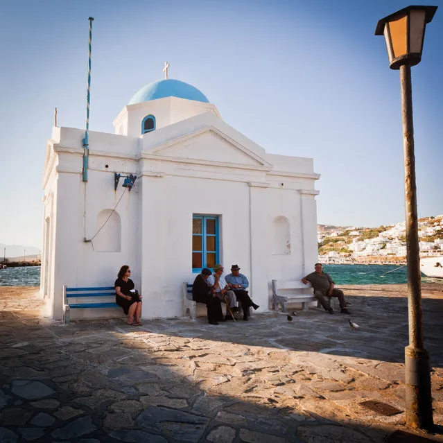 “Leisurely Greek Afternoon”. I took this photo in Mykonos, Greece. I loved how the three men in the middle were deep in conversation while there was one person on each bench on either side of them gazing off into the distance. I also loved the warm afternoon sun. (Photo and caption by Angie McMonigal/National Geographic Traveler Photo Contest)