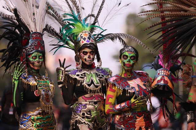 People dressed as “Catrinas” parade through the streets during celebrations ahead the Day of the Dead in Mexico City, Sunday, October 27, 2024. (Photo by Ginnette Riquelme/AP Photo)