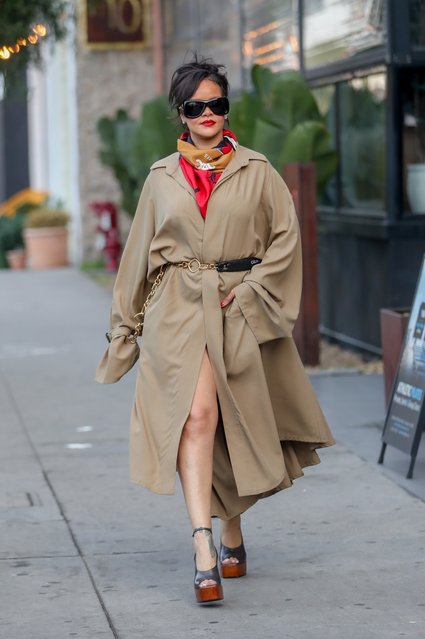 Barbadian singer Rihanna steps out in full fashion-command mode for a meeting in Hollywood, wearing an oversized trench cinched with a Celine chain belt, a bold silk scarf, and towering platform heels. With dark shades, red lips, and her hair swept up, the mogul strutted with unmistakable confidence, turning the sidewalk into her runway on December 12, 2025. (Photo by Backgrid USA)