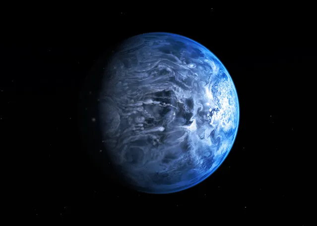 An artist's impression has been revealed today by NASA of the exoplanet HD 189733b. Like Earth, it is deep blue in colour, but its atmosphere is scorching with a temperature of over 1000 degrees Celsius, and it rains glass, sideways, in howling 7000 kilometre-per-hour winds, according to scientists. (Photo by NASA/ESA)