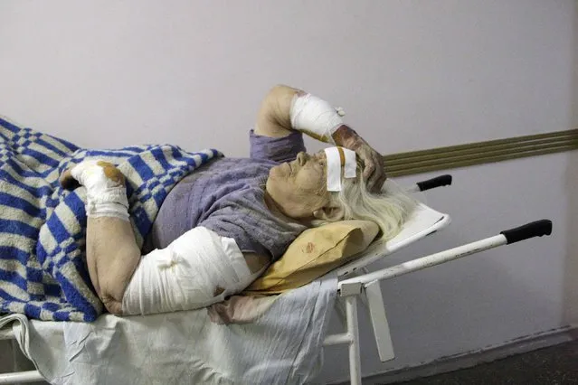 A woman, who according to locals was injured by recent shelling, lies on a stretcher at a hospital in Donetsk, eastern Ukraine, January 26, 2015. (Photo by Alexander Ermochenko/Reuters)