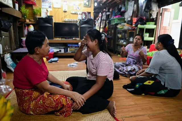 Family members of Sithu, 37, who was killed during a raid by security forces mourn at their home in Thaketa, Yangon, Myanmar on March 13, 2021. (Photo by Reuters/Stringer)
