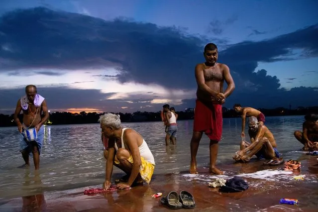 People are bathing on the bank of the Ganges River in Kolkata, India, on Tuesday, July 18, 2023. (Photo by Debajyoti Chakraborty/NurPhoto via Getty Images)