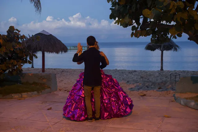 In this December 13, 2015 photo, Amanda Teresa Betancur, 15, who lives in Cuba, practices her opening dance with her boyfriend Erick before her quinceanera party in Havana, Cuba. (Photo by Ramon Espinosa/AP Photo)