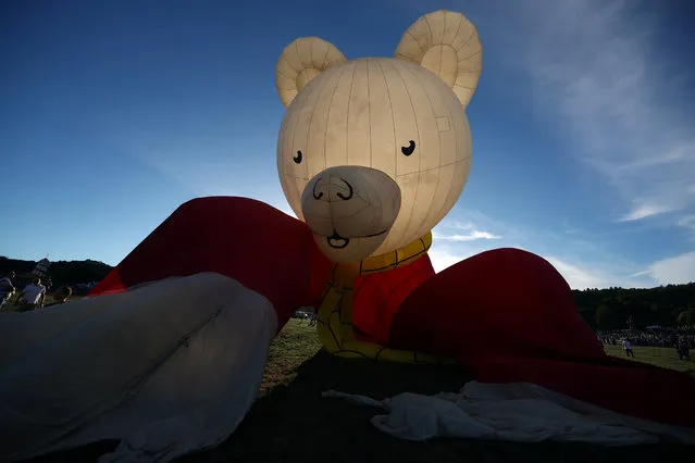 A hot air balloon in the shape of children's comic Rupert Bear is seen tethered before a tethered flight at the Bristol International Balloon fiesta in south west England, Britain, August 10, 2018. (Photo by Hannah McKay/Reuters)